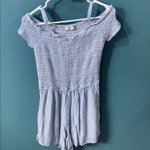 A light blue and white striped romper